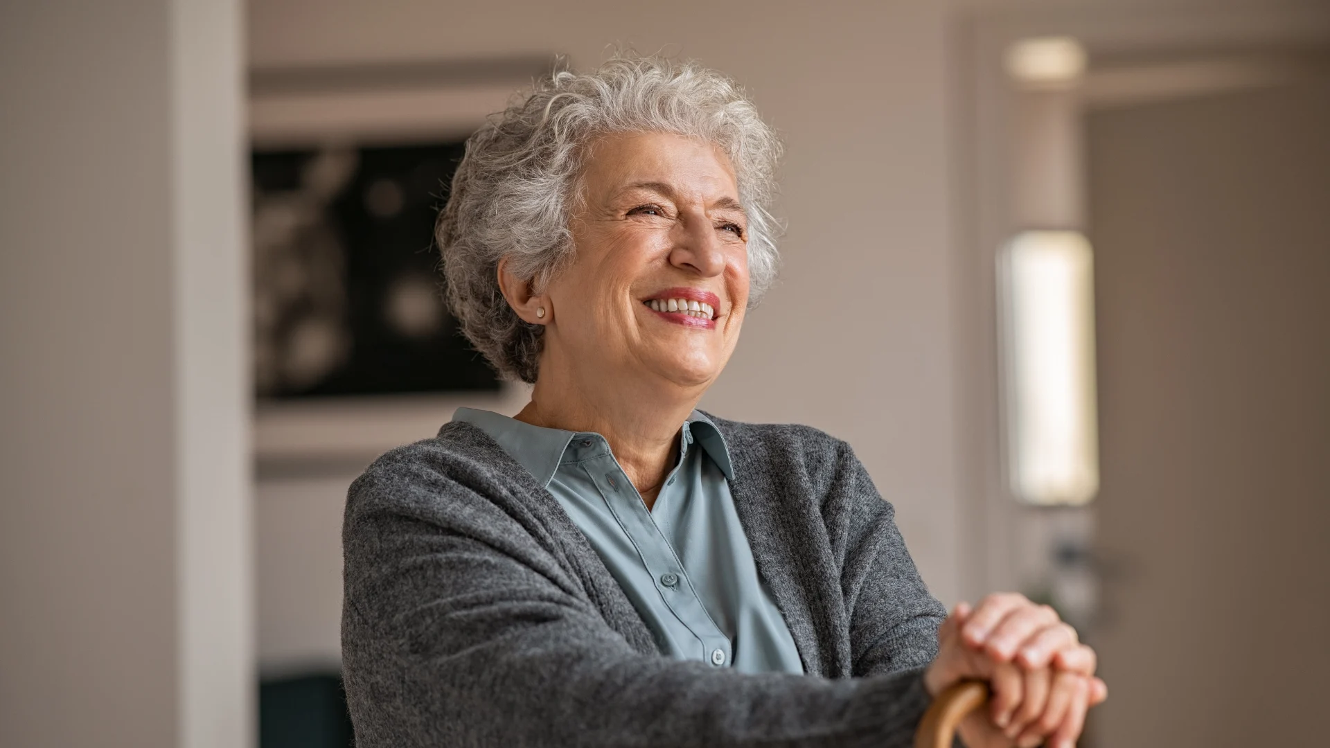 An older adult smiling comfortably at home