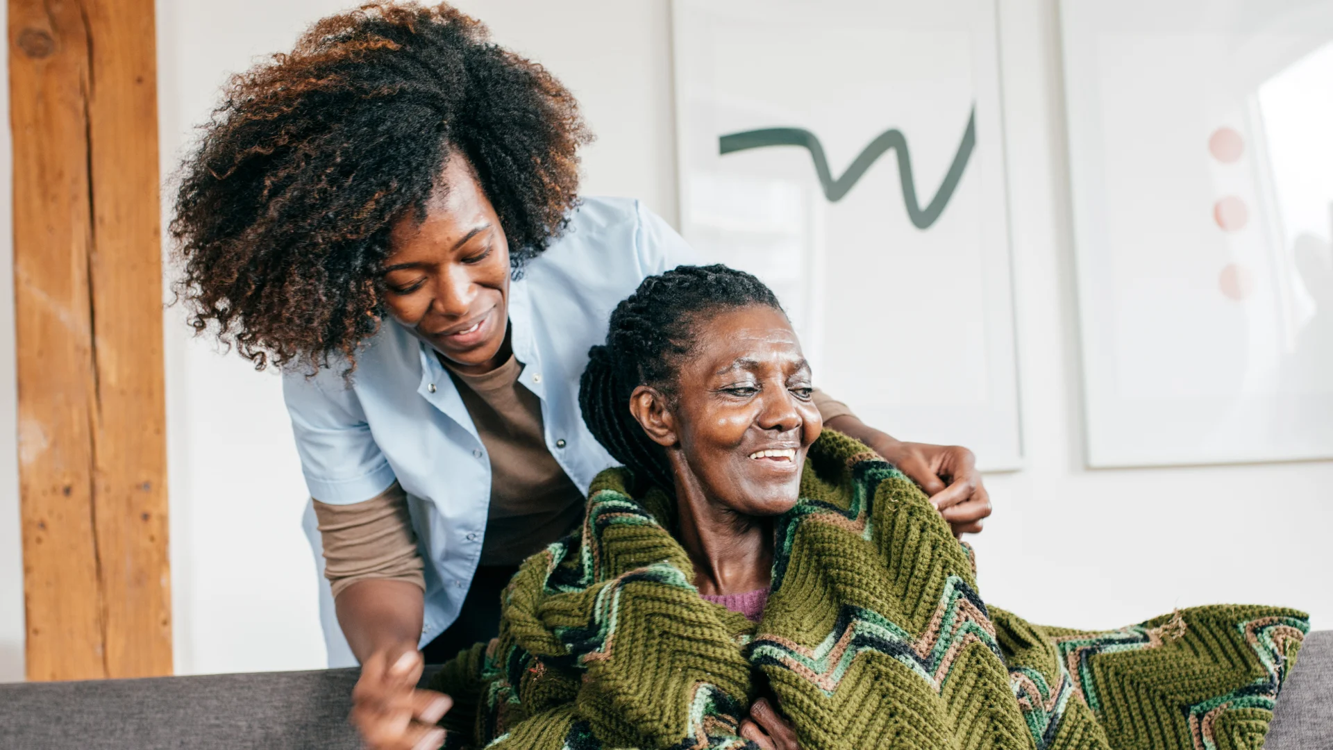 A caregiver sharing a reassuring embrace with an older client