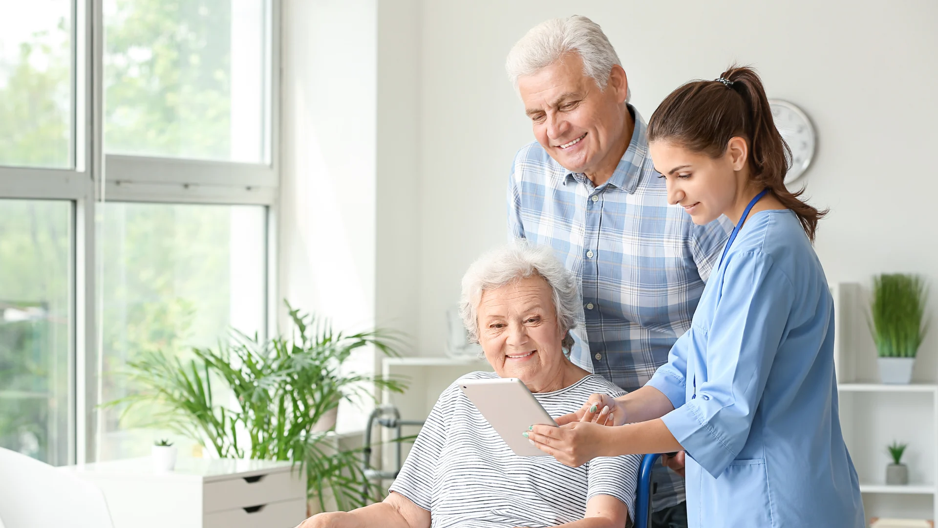 A caregiver supporting an older couple at home