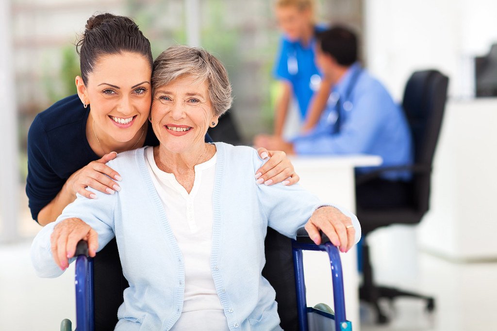 Adult daughter with her senior mother in a wheelchair